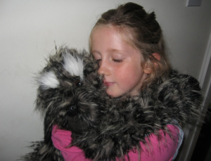 Young girl with dog puppet 